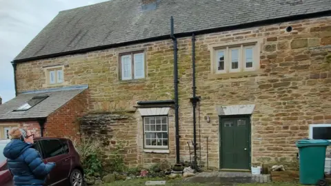 An old building with a green door. 