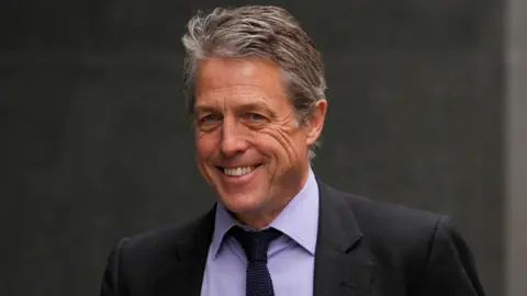 Reuters Hugh Grant walks outside the High Court, in London, Britain April 27, 2023.