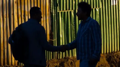 The silhouettes of two people in Addis Ababa