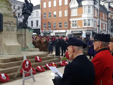Veterans stand at the war memorial