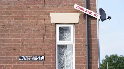 PA Media England Street sign above Wales Street