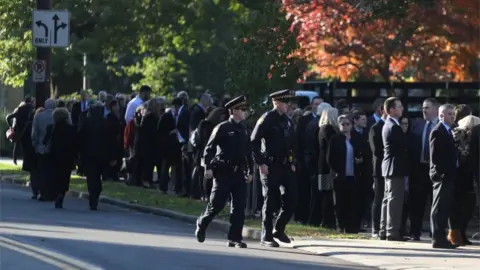 Reuters A long line has formed outside the Rodef Shalom Congregation ahead of the first funeral service for the victims