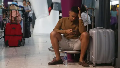 Getty Images Man waits at airport