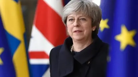 Getty Images Theresa May in between EU and UK flags