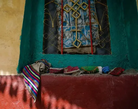 Getty Images Personal effects of parishioners and deacons killed at Chena Teklehaymanot Church in Chena, Ethiopia.