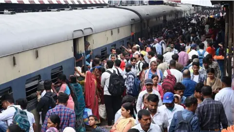 Getty Images Thousands board a train at Patna junction in Bihar to reach their hometowns