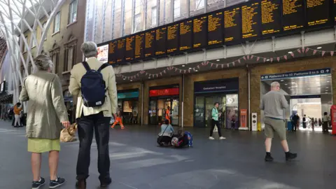 PA Media Passengers in at King's Cross