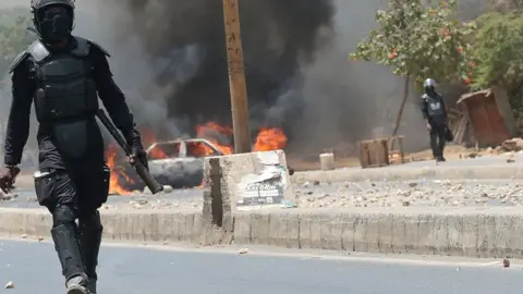 AFP Police officers block the entrance to the Cheikh Anta Diop University, in Dakar 3, during unrest following the sentencing of Ousmane Sonko - 1 June 2023