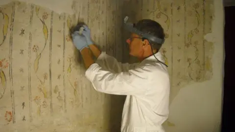 National Trust Peter Martindale working to restore the paintings