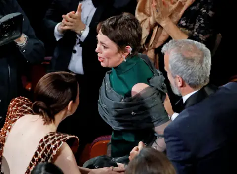 Reuters Olivia Colman stands to accept the Best Actress award