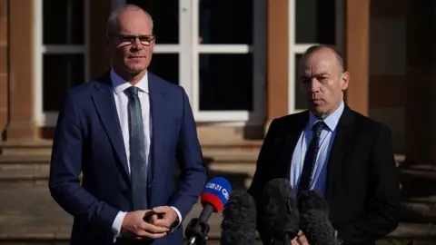 Niall Carson/PA Media Simon Coveney and Chris Heaton-Harris met at Hillsborough Castle last month