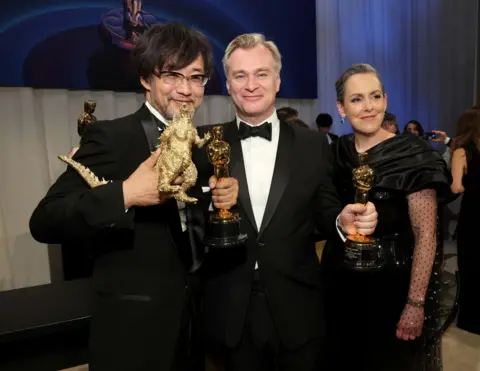 Getty Images Takashi Yamazaki, posing with the award for Best Visual Effects for "Godzilla Minus One" Christopher Nolan with the award for Best Picture for "Oppenheimer" and Emma Thomas attend the Governors Ball during the 96th Annual Academy Awards at Dolby Theatre on March 10, 2024 in Hollywood, California