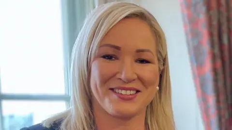 Michelle O'Neill smiles looking straight at the camera