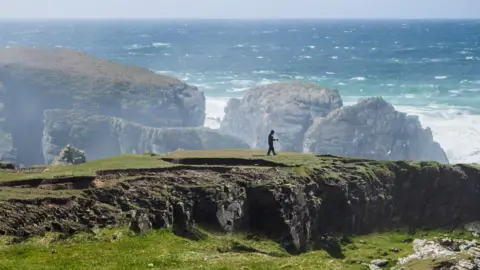 Getty Images A person walking at the Butt of Lewis in Lewis, Western Isles