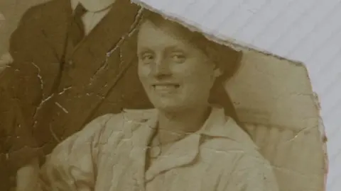 Louisa Dunne pictured smiling at the camera in a dress