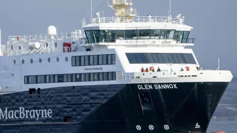 PA Media A large white and black ferry with the name 'Glen Sannox' wirtten on the side.