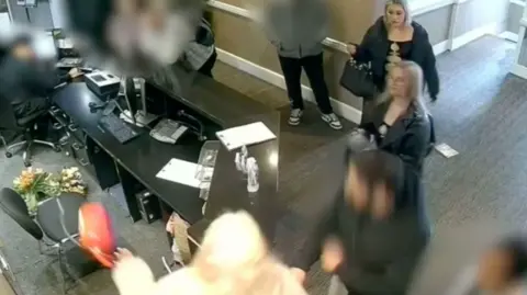CCTV footage from the hotel shows a number of people - some blurred out - near the reception desk
