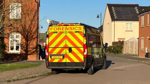 A police van parked on a residential street