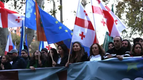 Getty Images Thousands of people waving European Union (EU), Georgian and Ukrainian flags participate in a protest on October 20 in Tbilisi