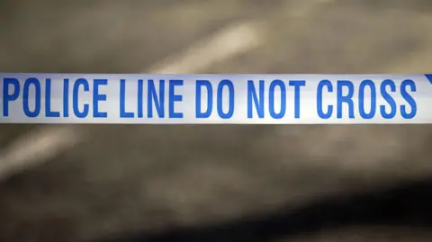 Blue and white "Police Line Do Not Cross" crime scene cordon tape.