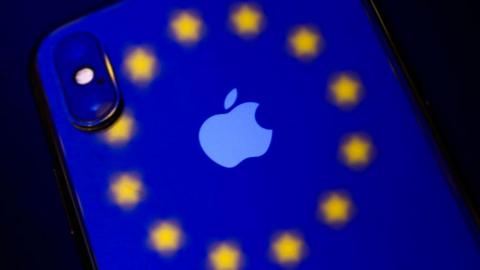 An iPhone with the EU logo projected onto it