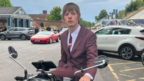 Travis on a scooter at his school prom
