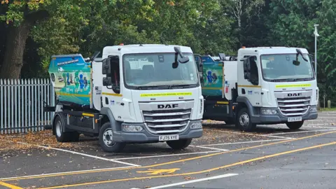 MSDC Two lorries with tippers on the back, they have the words 123 on the side
