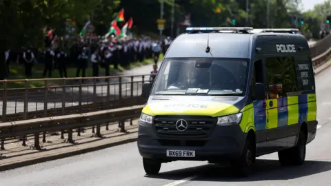 Reuters A police vehicle stands in the road as people from pro-Palestinian activist groups gather near the Edgware United Synagogue, during a demonstration.