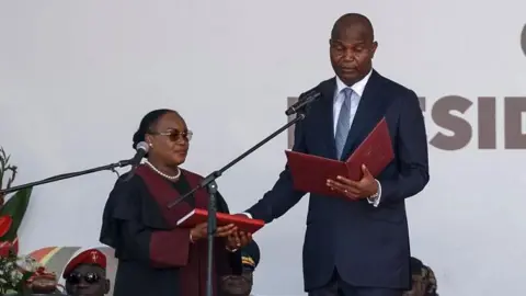 AFP Daniel Chapo wears a dark blue suit with a light tie as he is sworn in as Mozambique's fifth president 