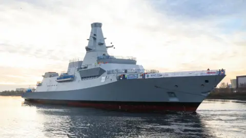 UK MOD Crown Copyright HMS Glasgow, aType 26 Frigate, makes its way to Scotstoun shipyard after being successfully floated on the Clyde.