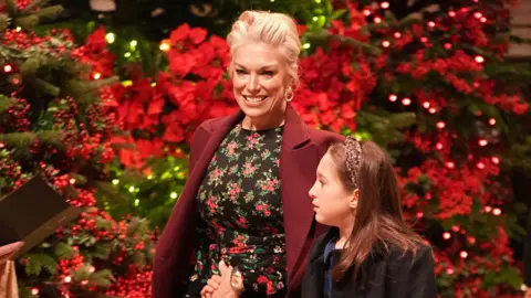 Aaron Chown/PA Wire Hannah Waddingham smiles as she arrives at Westminster Abbey, accompanied by a child.