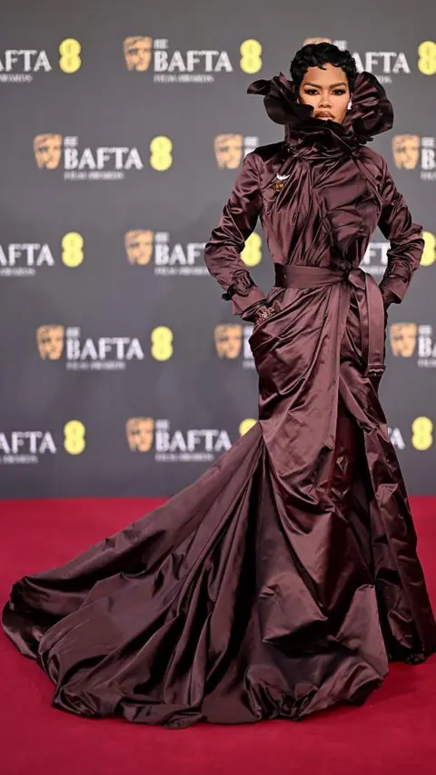 Getty Images Teyana Taylor in a brown, silk ruffled dress