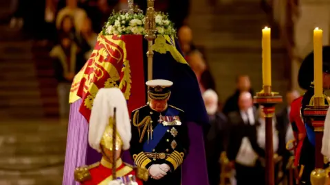 Reuters King Charles III stands vigil