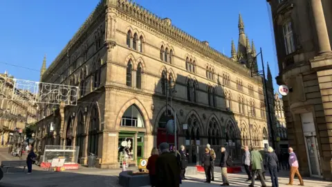An exterior GV of Bradford's Wool Exchange in the city centre on a sunny day