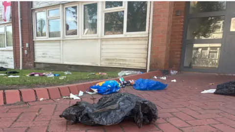 Local Democracy Reporting Service Rubbish on a brick floor.