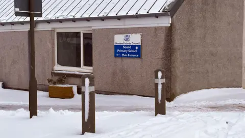 A primary school building surrounded by snow