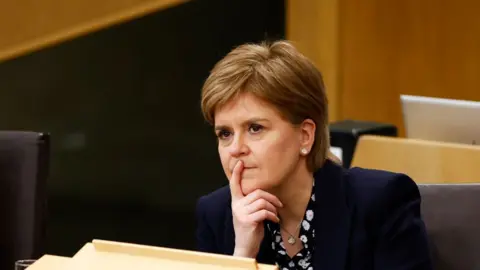 Getty Images Outgoing First Minster of Scotland Nicola Sturgeon listens while attending the Scottish Parliament on March 28, 2023