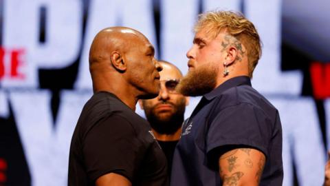 Mike Tyson and Jake Paul stand face to face