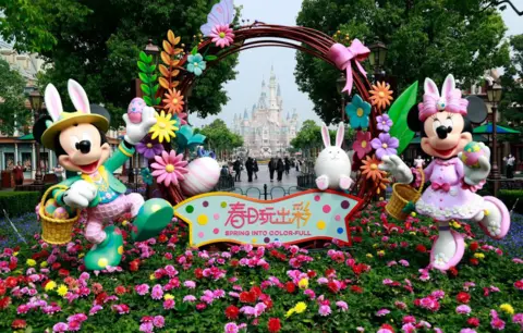 China News Service/Getty Images Visitors wearing face masks