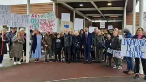 Group of protestors outside Linden Court - a day service for people with learning disabilities in Eastbourne