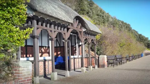 Sussex Police A seafront shelter on an esplanade with benches around it