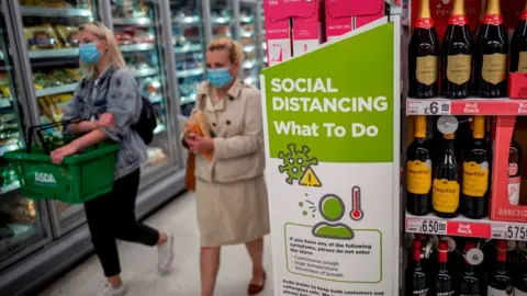 Getty Images Asda shoppers wearing face coverings