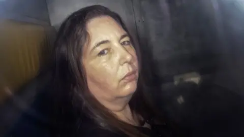 Headshot of Erin Patterson as she looks at the camera in the back of a prison vehicle in Morwell on 12 May.