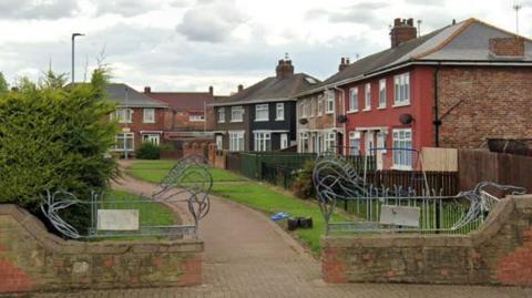 A path leading between a row of houses