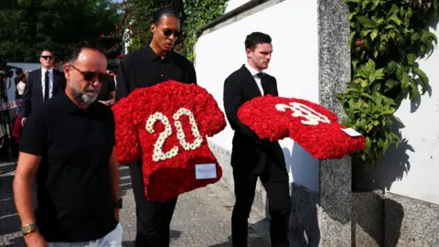 Football players arrive at the funeral of Diogo Jota wearing dark clothes.