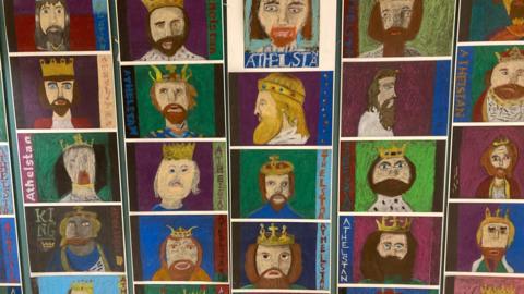 A collage of childrens drawings of the portrait of a king