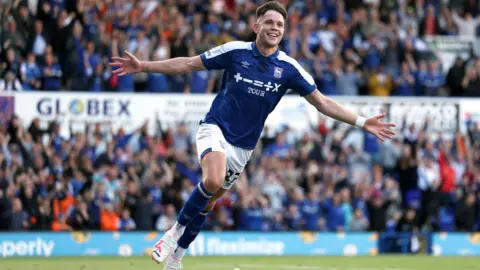 George Tewkesbury/PA Media Hirst runs across the pitch after scoring with his arms outstretched at his sides