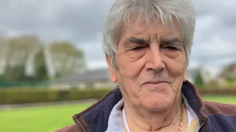 Shariqua Ahmed/BBC Richard, a man with white hair, wearing a blue and brown sleeveless jacket.