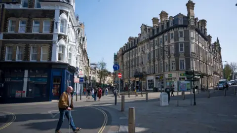 Getty Images Shoppers go about their business on Newport's High Street. 