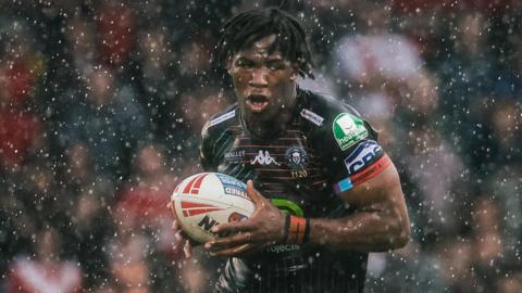 Junior Nsemba holds the ball in soggy conditions